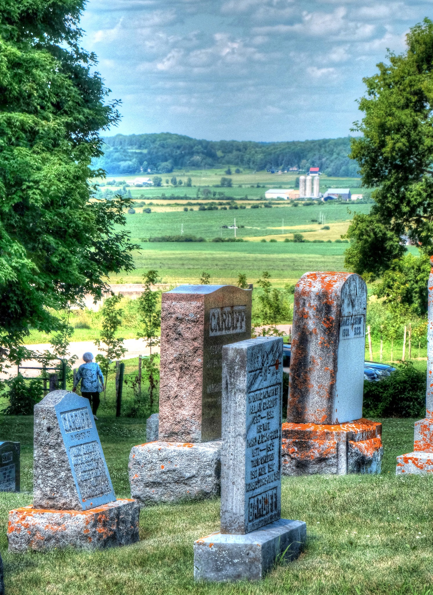 Elevated view from cemetery markers toward surrounding landscape.